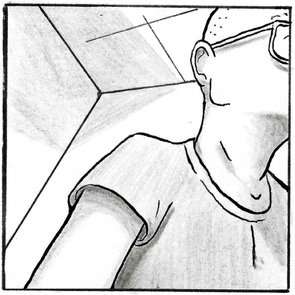 A low angle shot of a male nurse wearing glasses. He is looking off-frame at a screen, his hands reach below the panel.