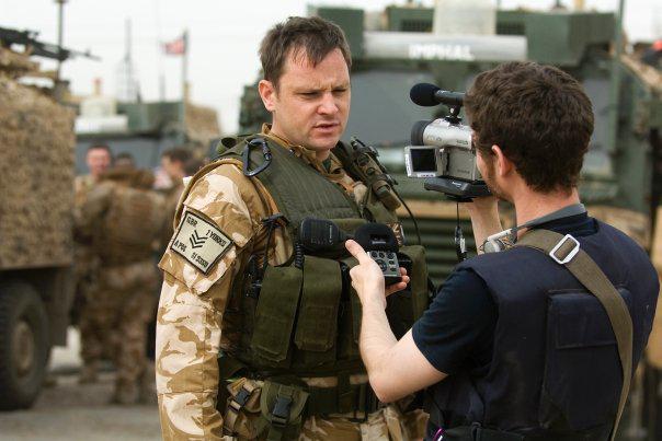 A photo of Adam Westbrook interviewing a British soldier in Iraq, March 2009 - by Laurence Roche