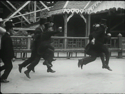 A scene from Entr&rsquo;acte, showing edwardian men skipping in a circle