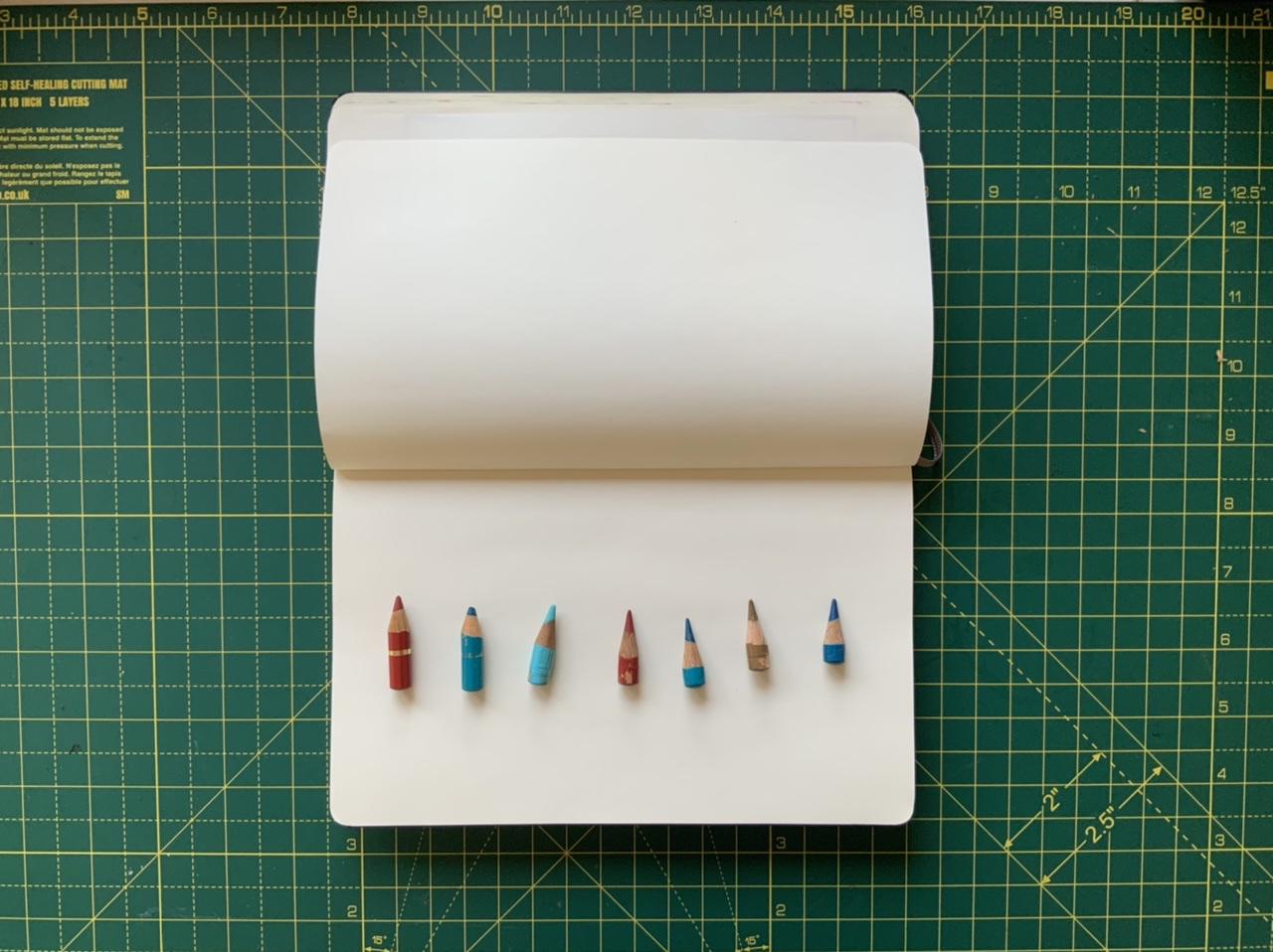 A photo of some worn down pencils and Adam Westbrook&rsquo;s sketchbook