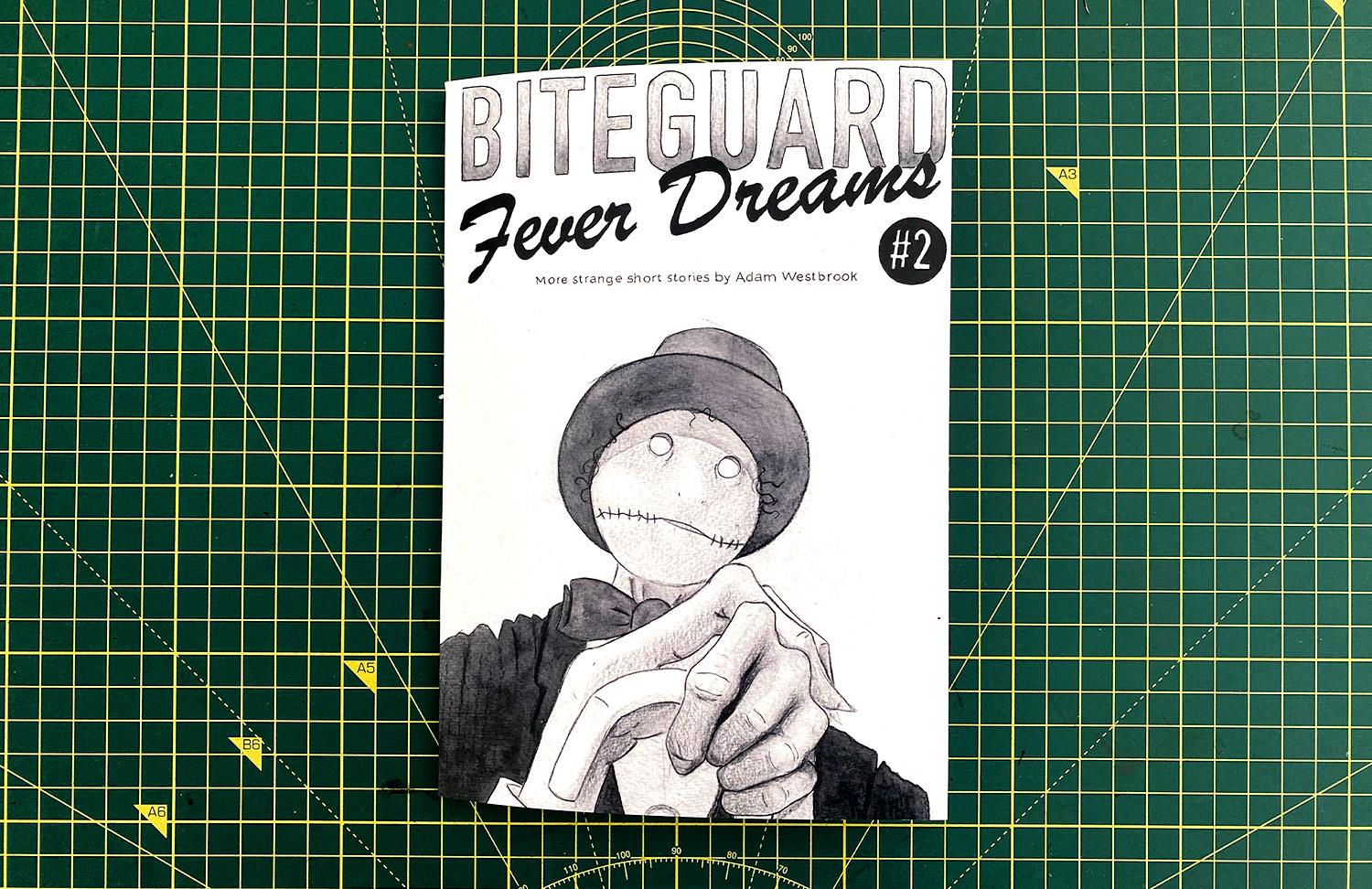 A photograph of Adam holding a copy of Biteguard Fever Dreams issue 2