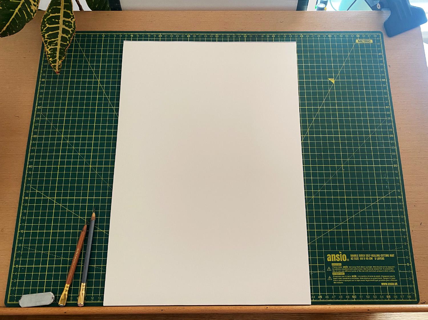 A photograph of Adam&rsquo;s desk with a clean sheet of A3 paper on it